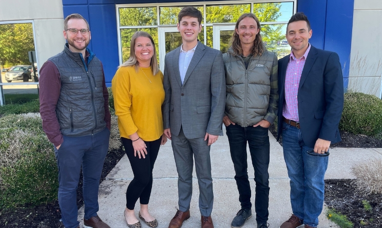 5 SPARK team members standing in front of a building